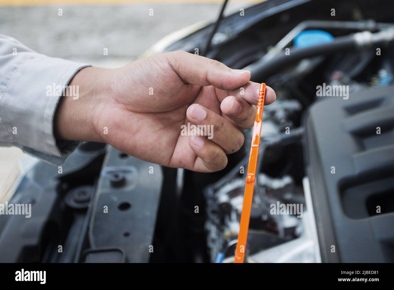 Car mechanic check oil level Stock Photo Alamy