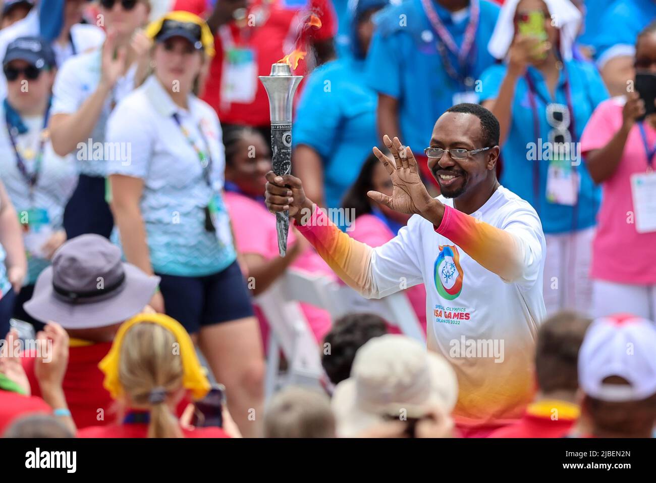 Orlando, Fl, US, June 5, 2022 Athlete DION THOMAS runs with the torch