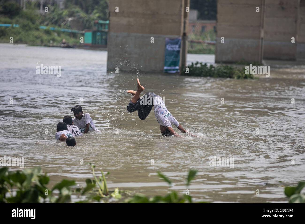 Children take baths in the polluted Buriganga River in Dhaka