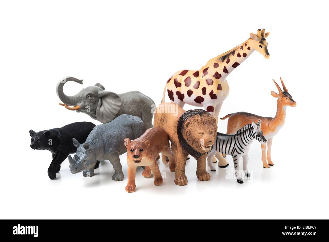 Group of jungle animals toys isolated over white background. Plastic animals toys. Stock Photo
