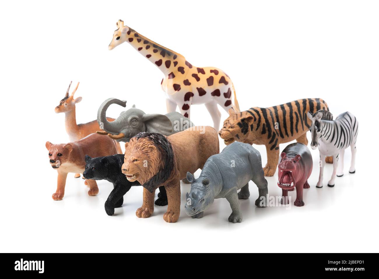 Group of jungle animals toys isolated over white background. Plastic animals toys. Stock Photo