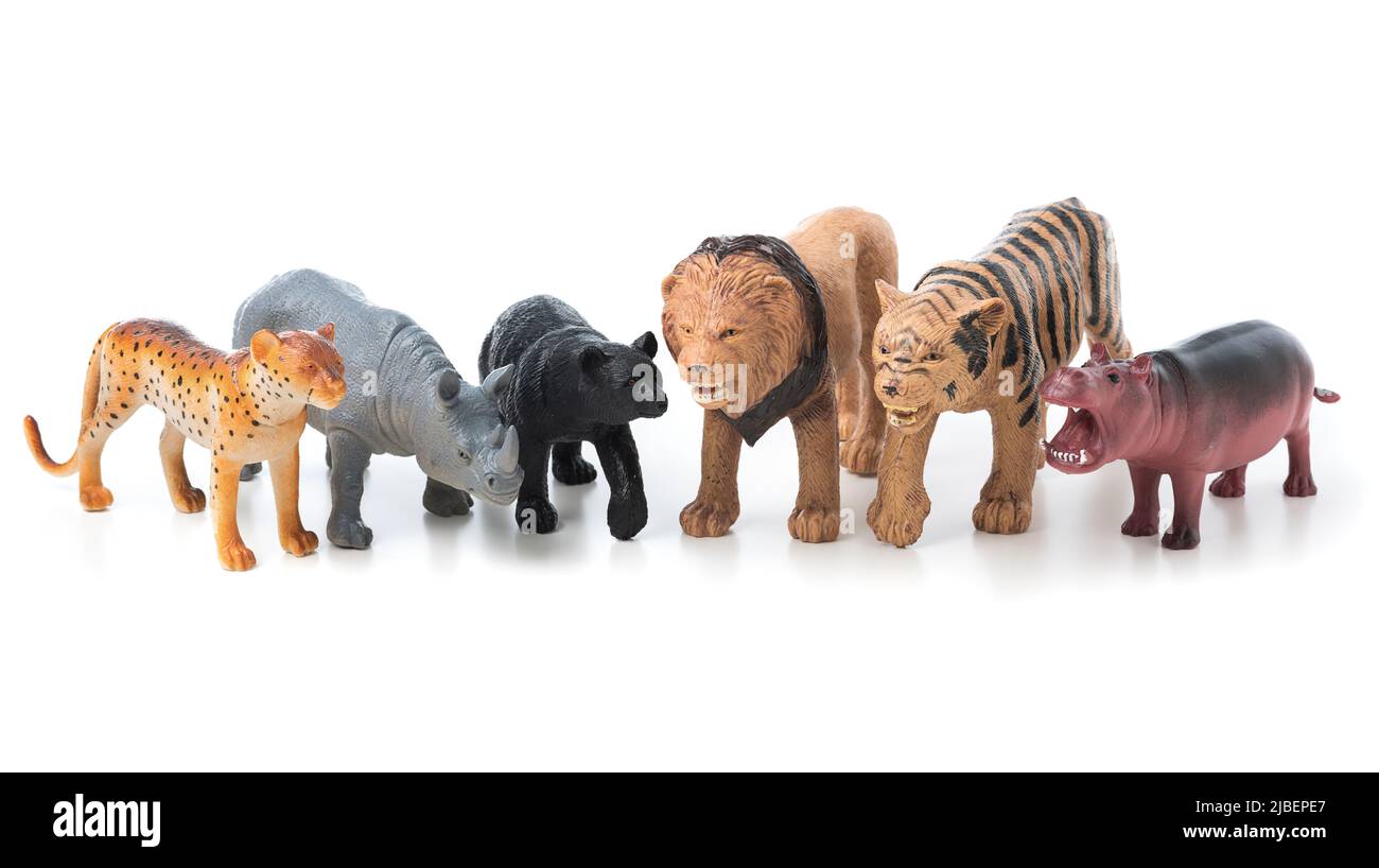 Group of jungle animals toys isolated over white background. Plastic animals toys. Stock Photo