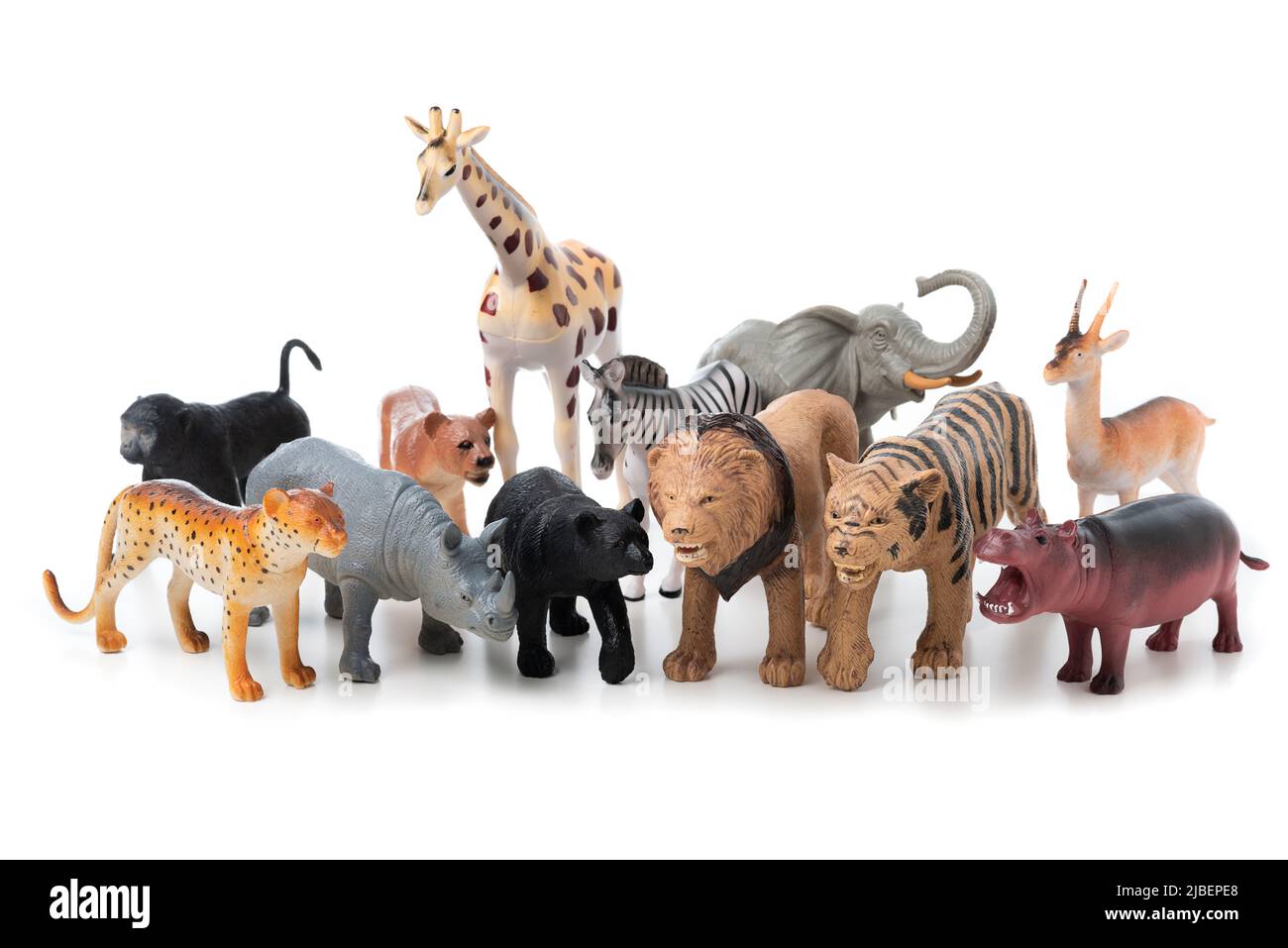 Group of jungle animals toys isolated over white background. Plastic animals toys. Stock Photo