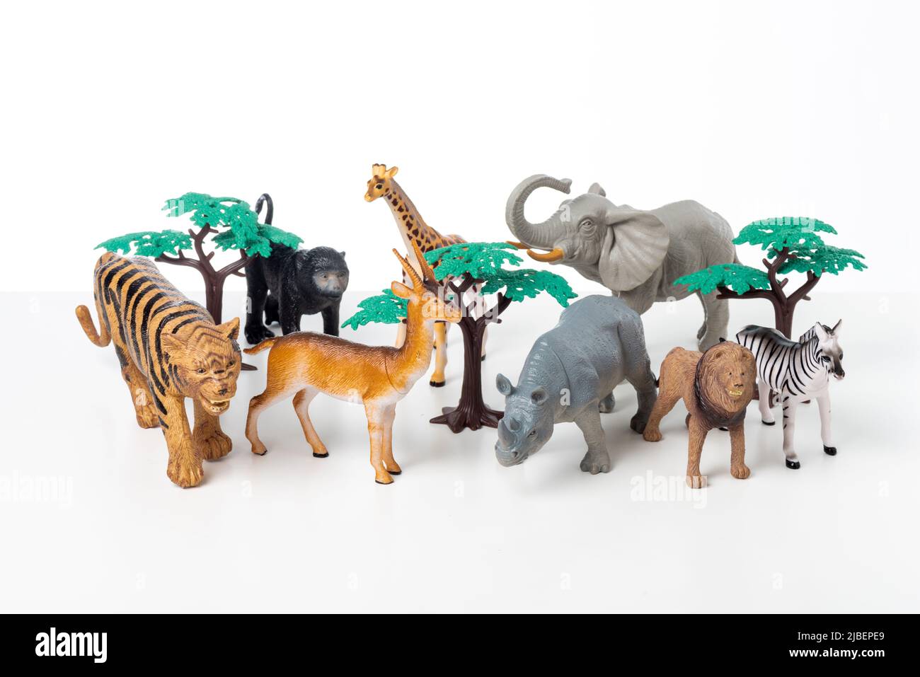 Group of jungle animals toys isolated over white background. Plastic animals toys. Stock Photo