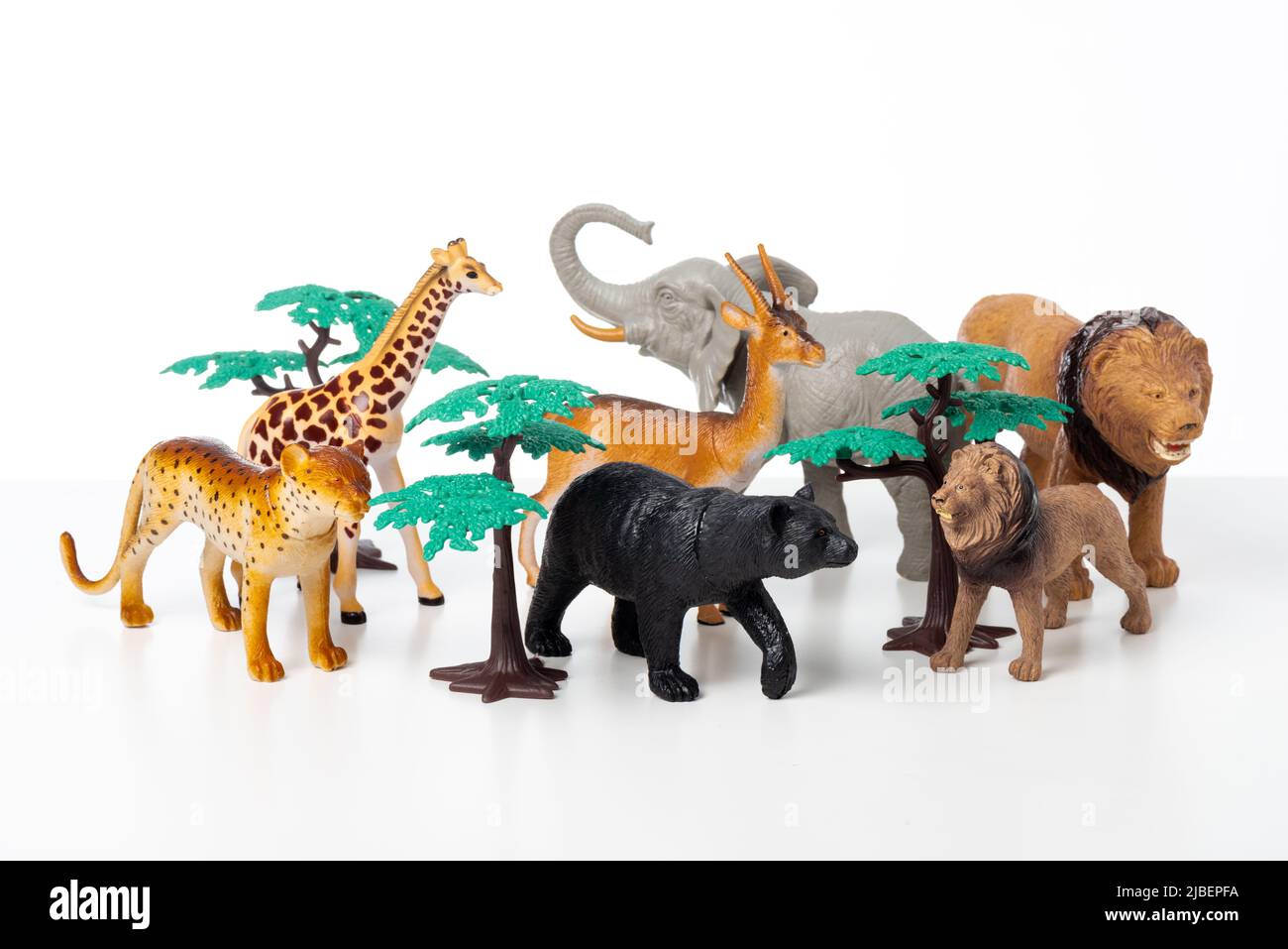 Group of jungle animals toys isolated over white background. Plastic animals toys. Stock Photo