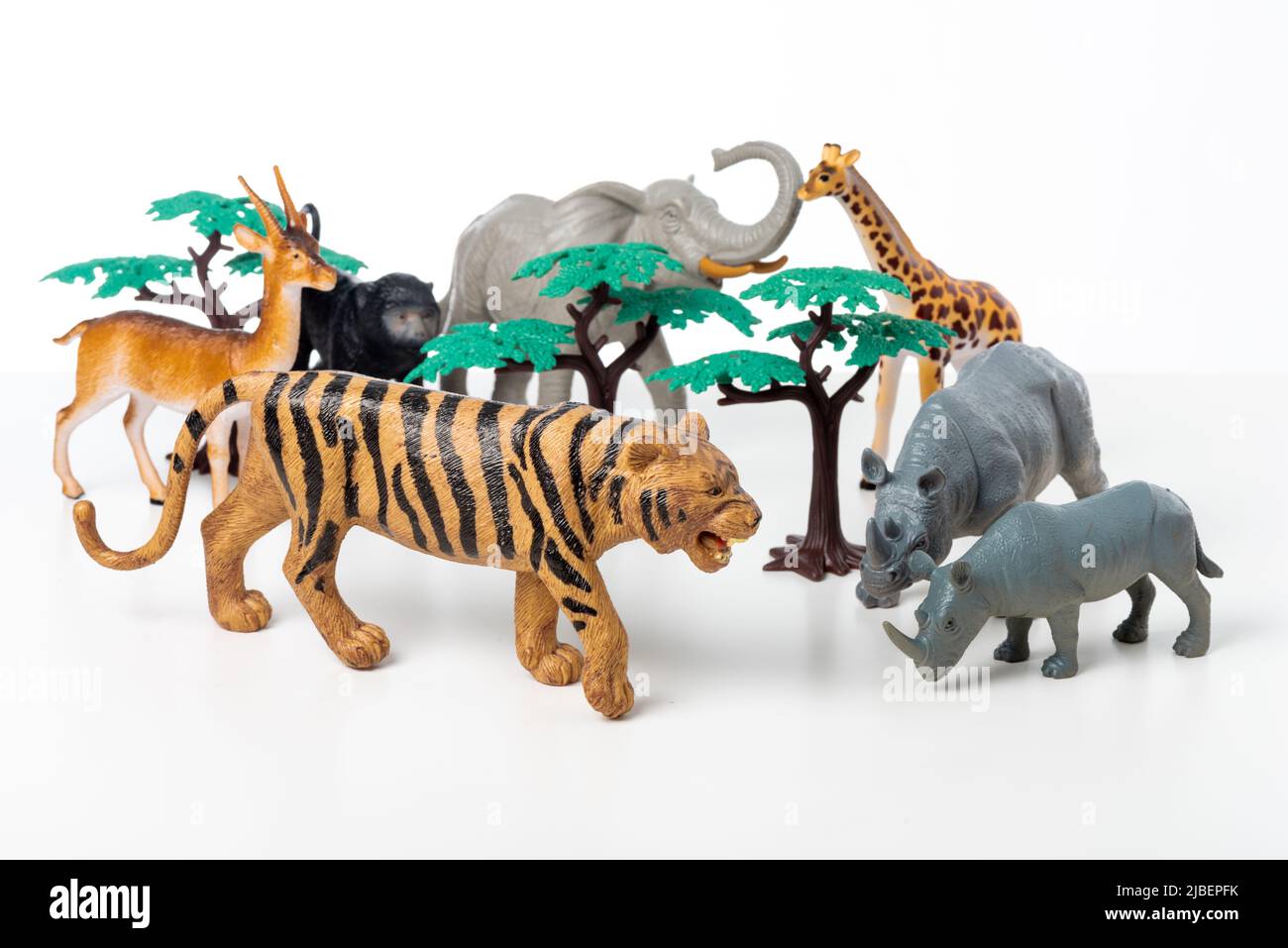 Group of jungle animals toys isolated over white background. Plastic animals toys. Stock Photo