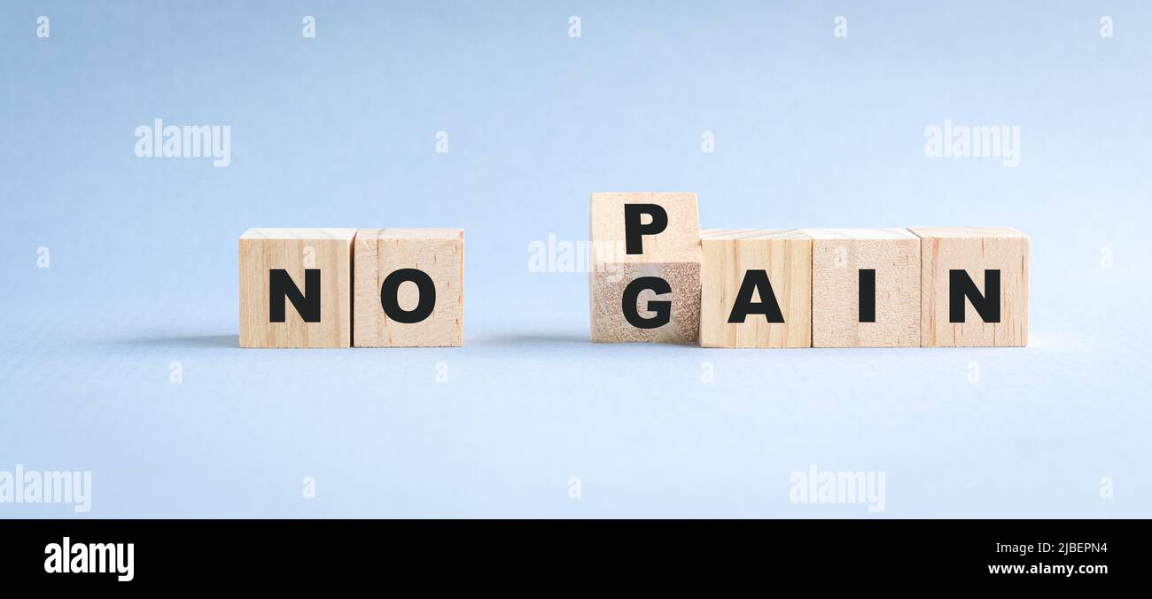 Wooden cube blocks with word flip from no pain to no gain. Stock Photo