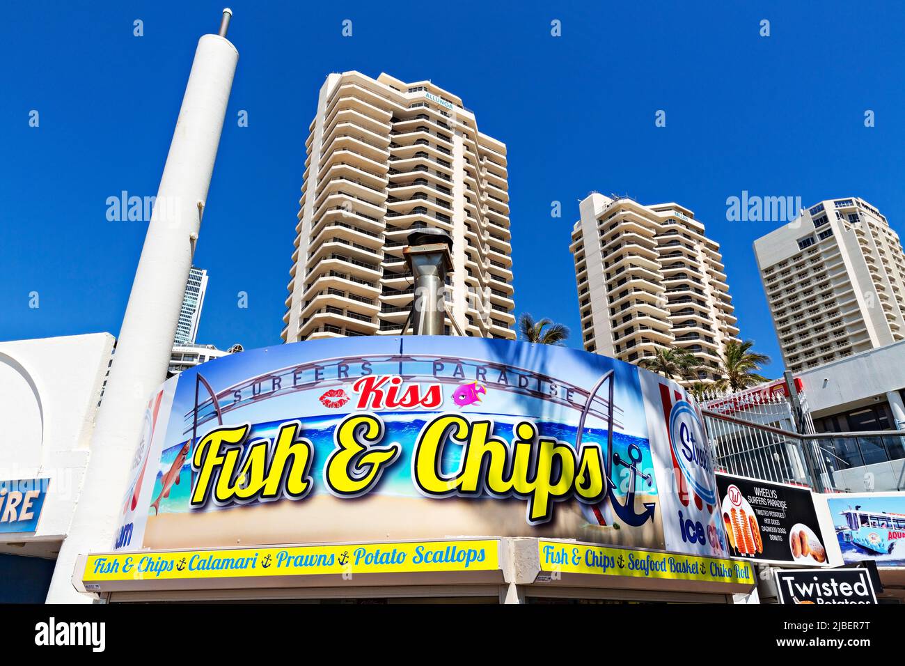 Queensland Australia /  Holiday apartments tower above a Fish & Chips eatery at Surfers Paradise. Stock Photo