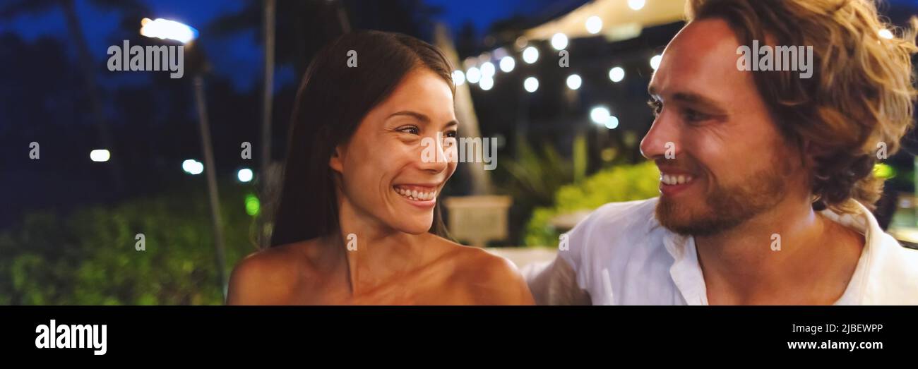 Dating couple in love on online first date at bar on night out banner panoramic. Asian woman, Caucasian man having fun laughing smiling, biracial Stock Photo