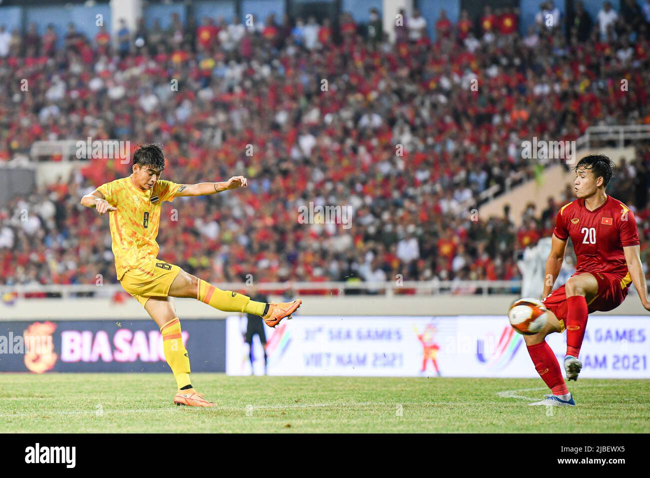 Korawich Tasa (L) of Thailand and Anh Bui Hoang Viet (R) of Vietnam in action during the Sea Games 2022 match between Thailand and Vietnam at My Dinh National Stadium. Final score; Thailand 0:1 Vietnam. Stock Photo