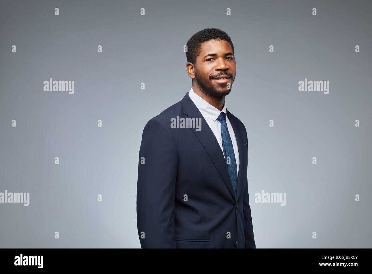 Portrait of adult black man wearing business suit and smiling at camera ...
