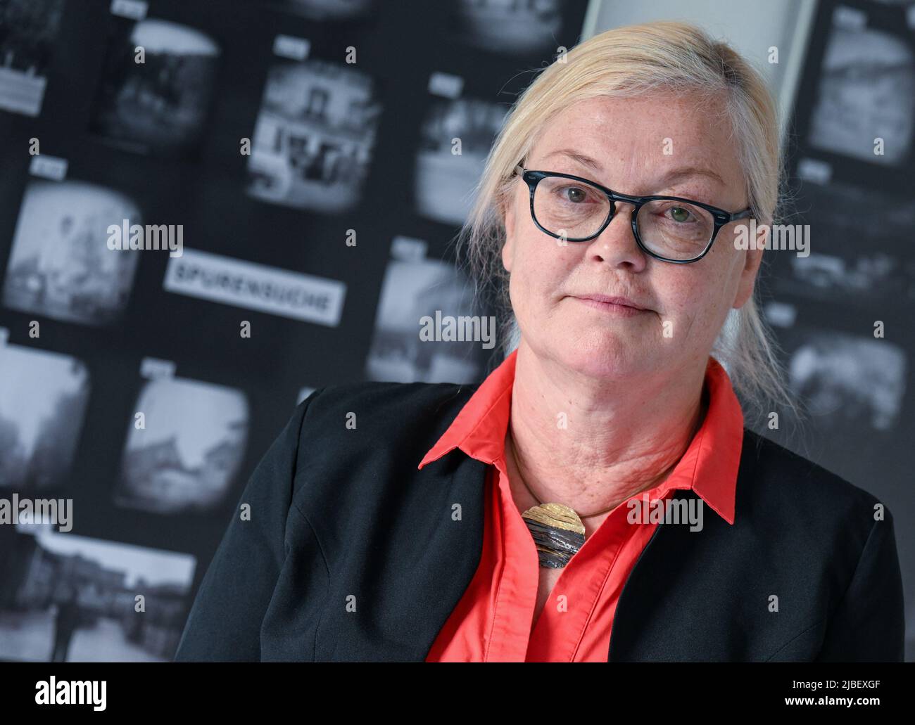 PRODUCTION - 24 May 2022, Saxony-Anhalt, Halle (Saale): Marit Krätzer, head of the Stasi Unterterlagenarchiv in Halle/Saale, stands in the photo exhibition 'Spurensuche'. In the series, the archive exhibits photographs that have not yet been assigned. The archivists hope for further information. (to dpa: 'Help needed for Operation 'Trace Search' in the Stasi Archive in Halle') Photo: Hendrik Schmidt/dpa Stock Photo