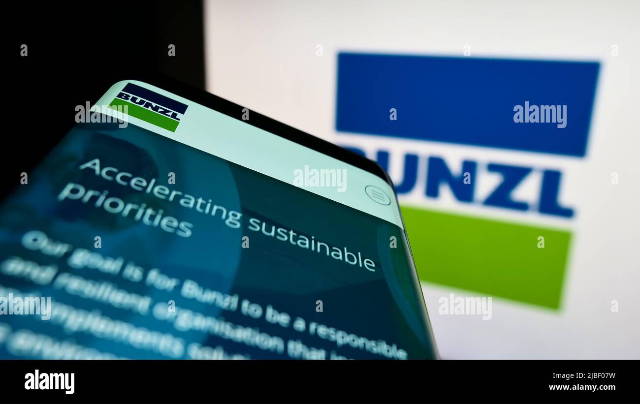 Mobile phone with webpage of British distribution company Bunzl plc on