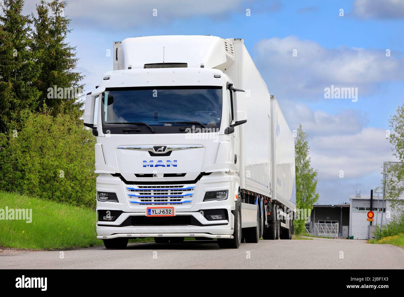 White, new MAN TGX 26.510 truck in front of refrigerated trailer parked on asphalt yard. Salo, Finland. May 29, 2022. Stock Photo