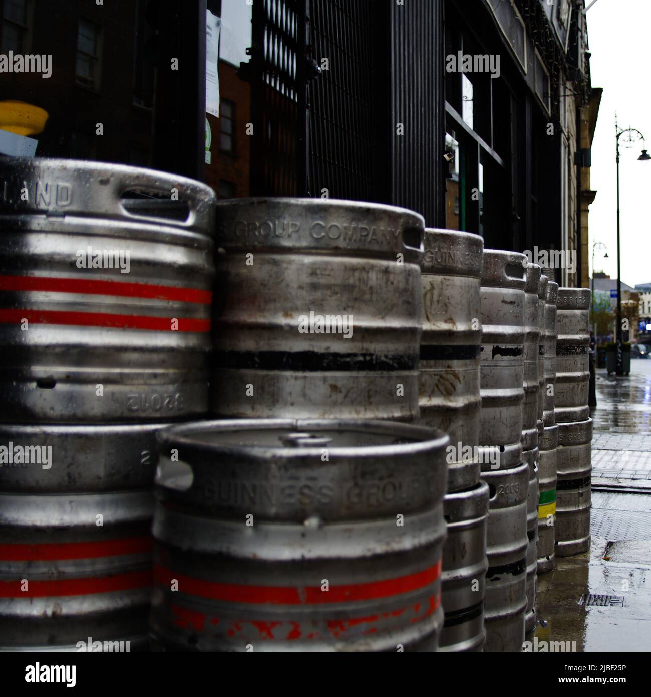 Dublin, Ireland - May 17th 2022: Aluminium beer kegs by Guinness Brewery stacked in front of a pub in Dublin Stock Photo