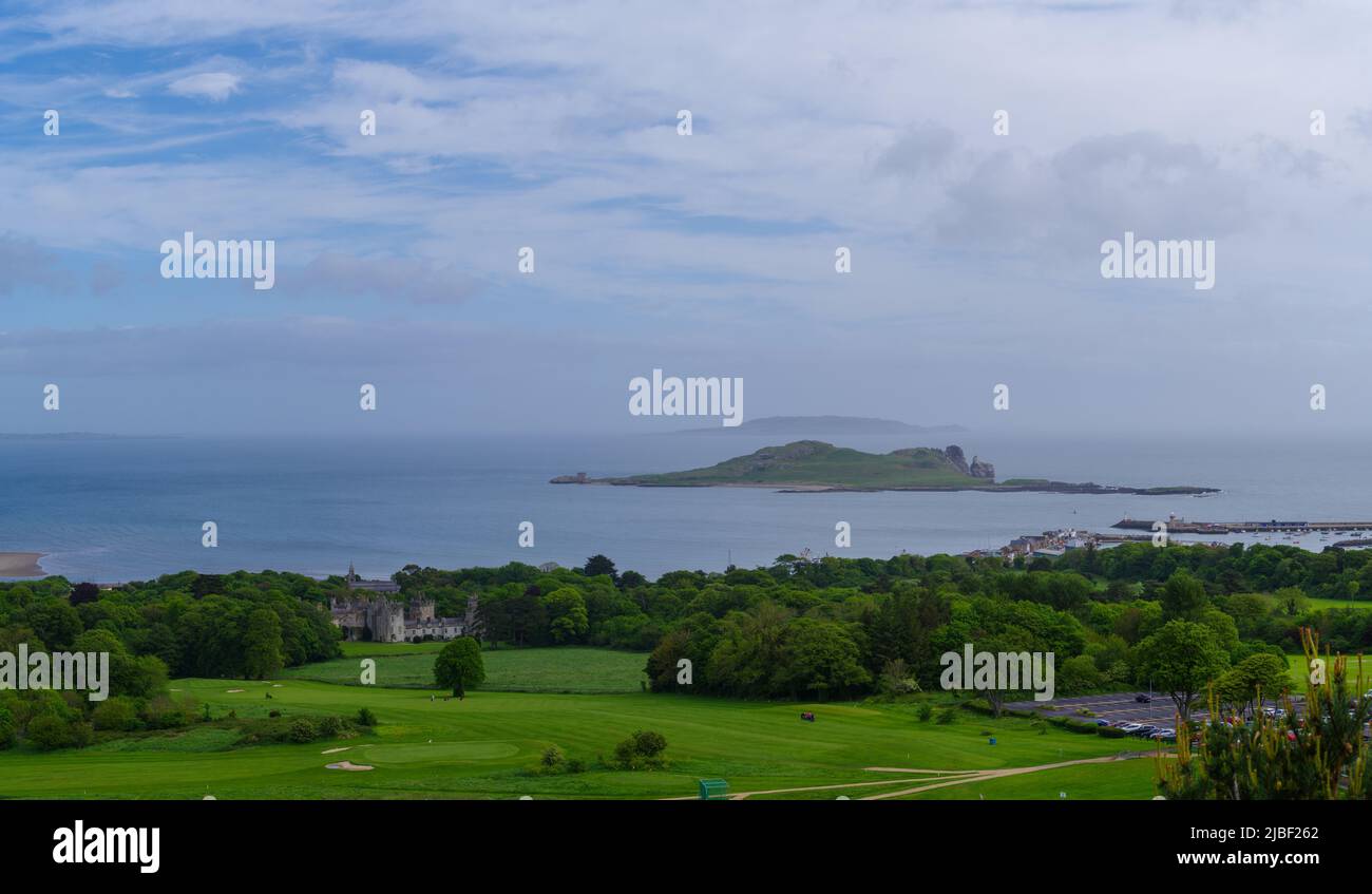 Ireland's Eye island as seen from Howth with Howth Castle in the mid ...