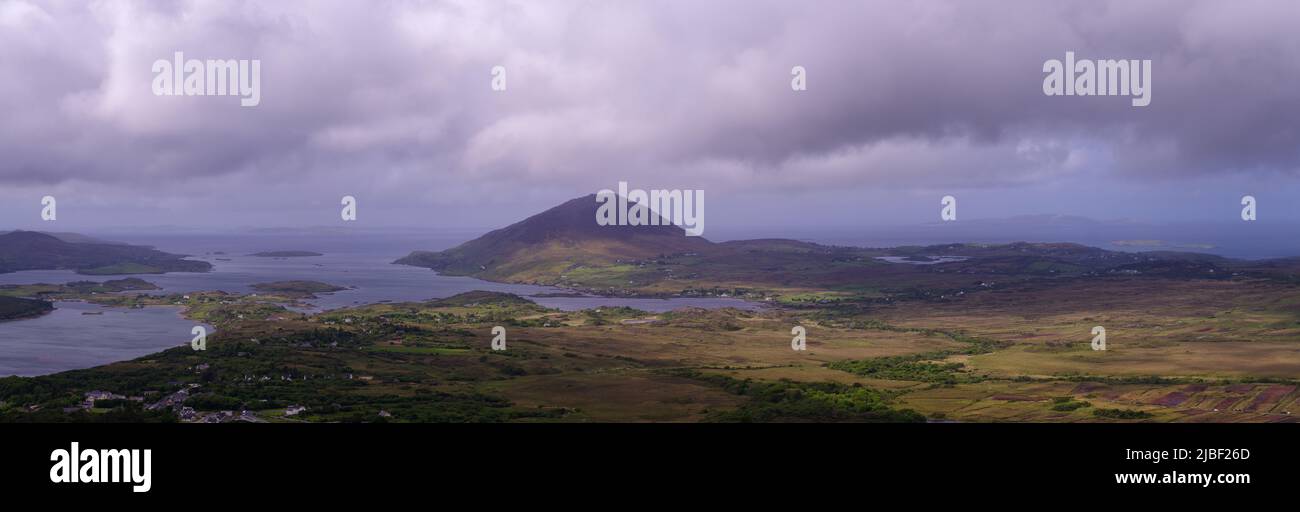 scenic panoramic vista over Connemara National Park with heavy clouds and some sun in Spring Stock Photo