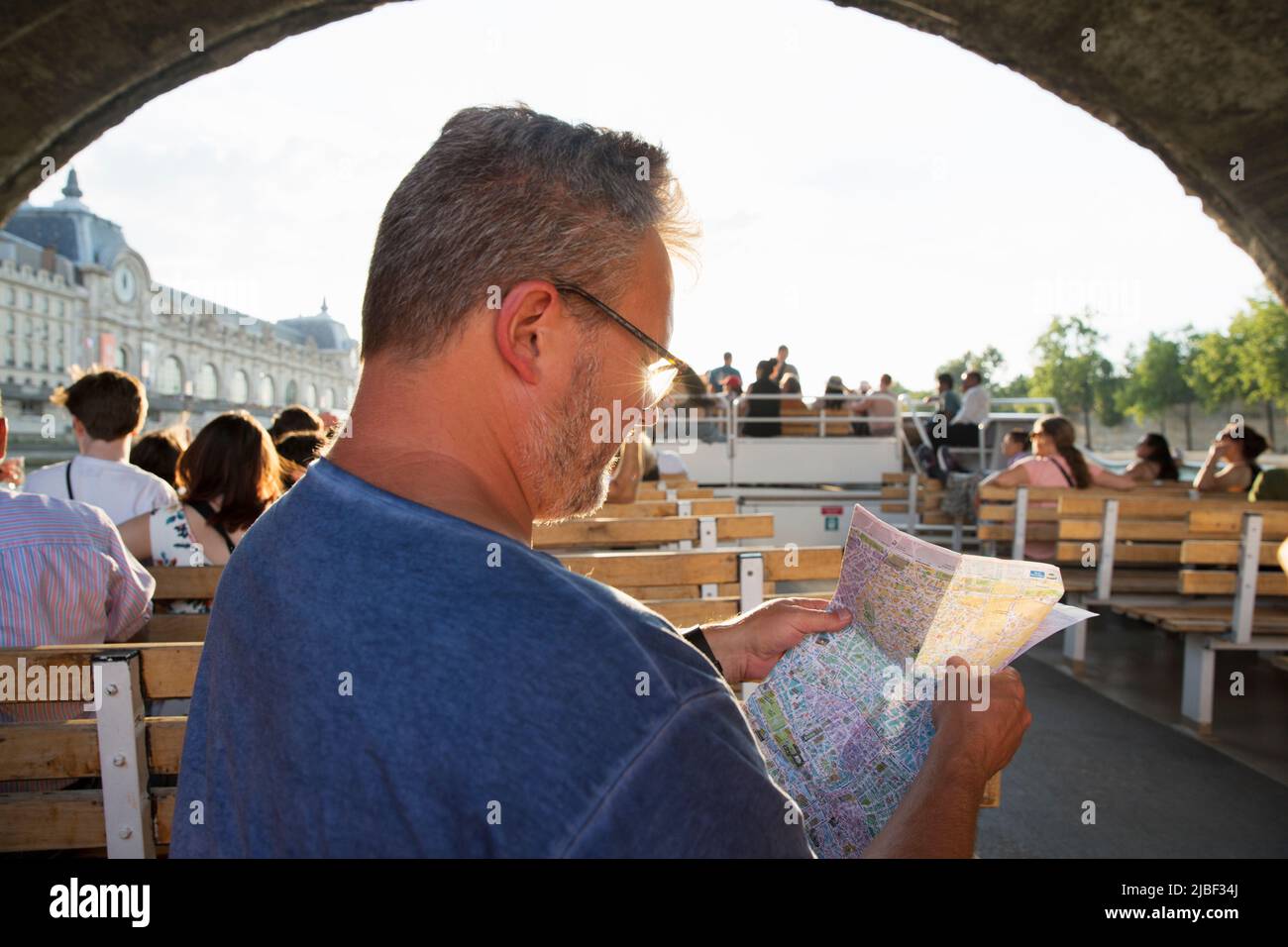 Mid adult man on tour boat on River Seine, Paris, France Stock Photo