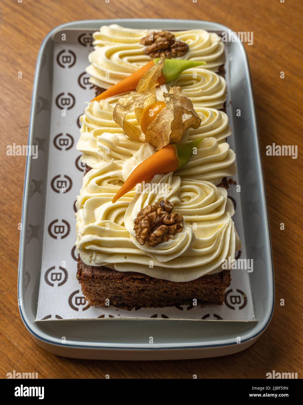 Typical dessert of the Danish festival. Carrot cake with butter cream, Chinese lantern, nuts and carrots. Assens, Denmark, Europe Stock Photo