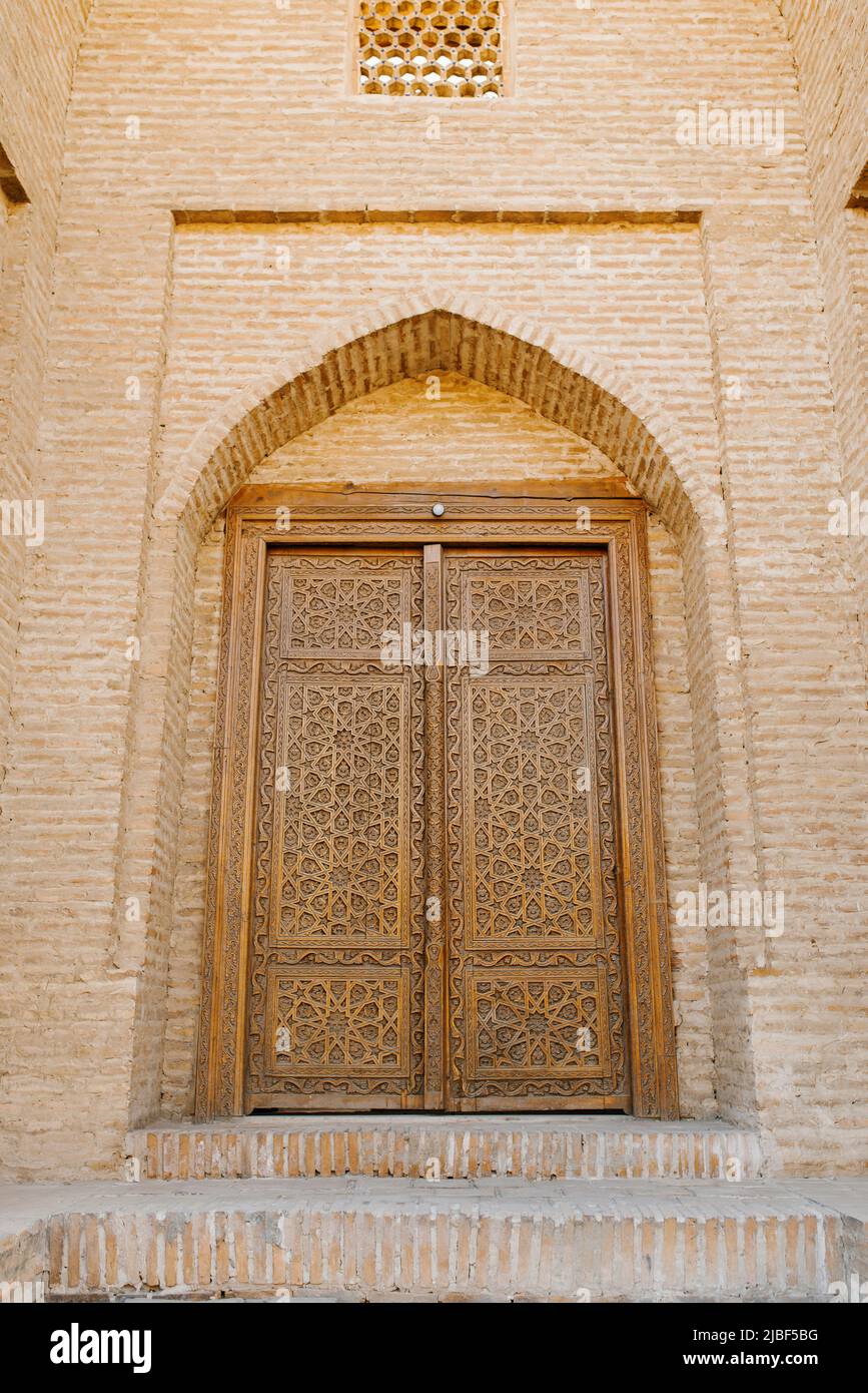 Bukhara, Uzbekistan. March 2022. Carved wooden door in oriental motifs Stock Photo
