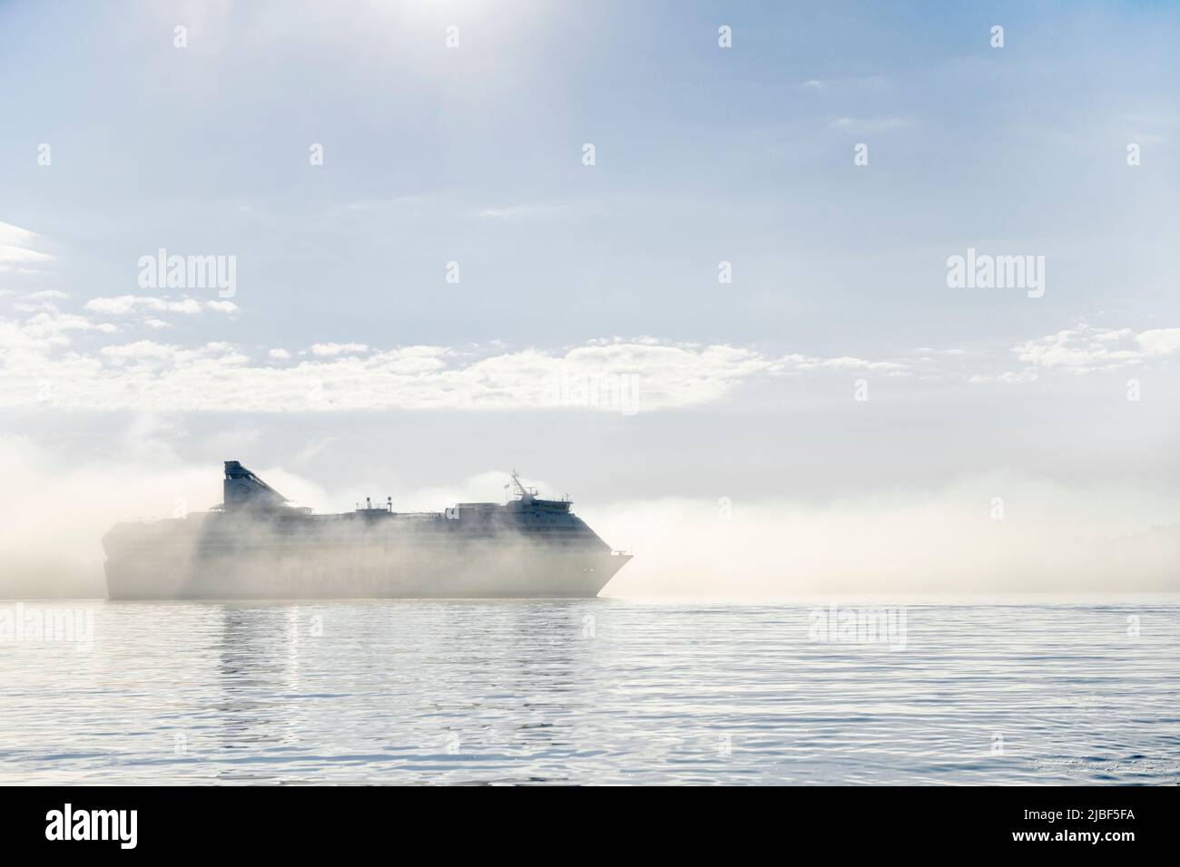 Cruise ship in fog on Baltic Sea in Hoggarns Bay, Lidingo, Sweden Stock Photo