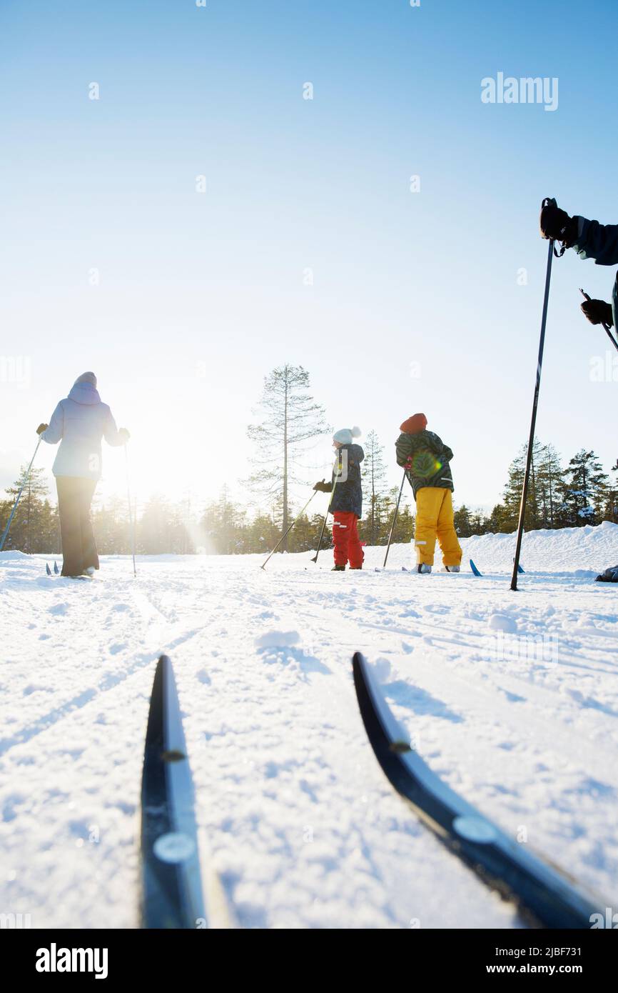 Family of four skiing on mountain Stock Photo