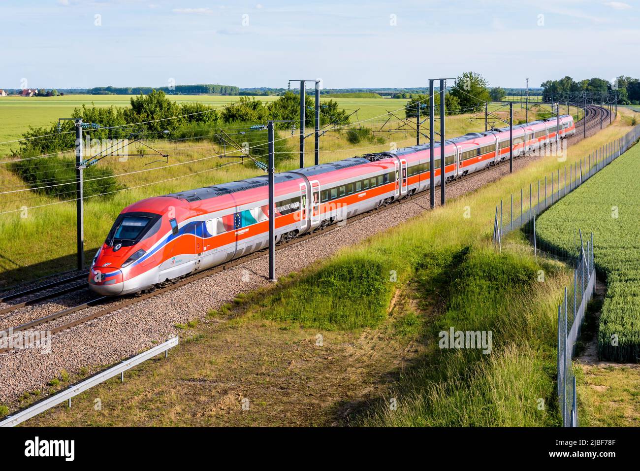 A Frecciarossa (ETR 1000) high speed train from italian rail company Trenitalia is driving from Lyon to Paris on the LGV Sud-Est in the countryside. Stock Photo