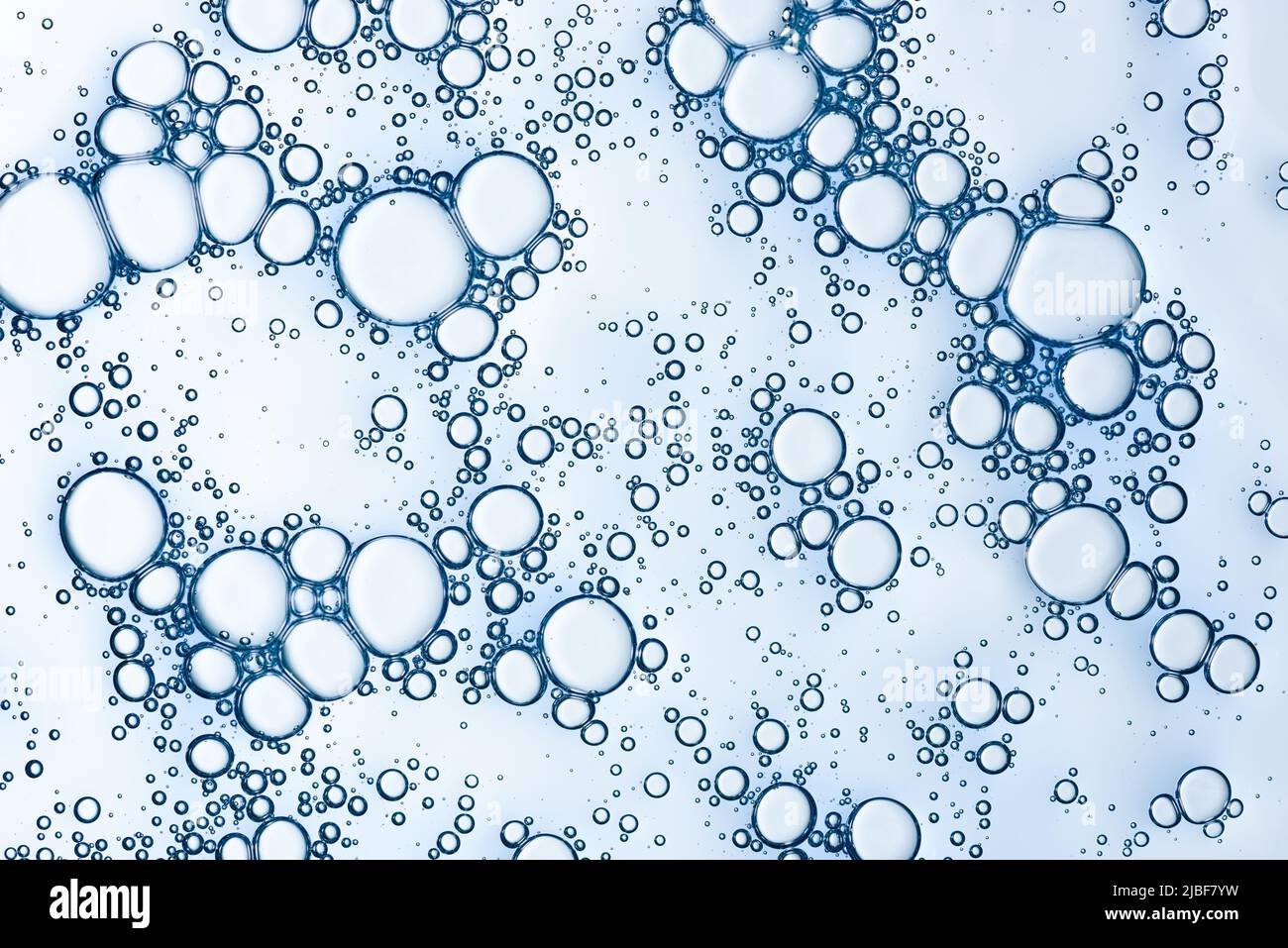 Oxygen bubbles in liquid skicare gel serum macro texture background top view Stock Photo