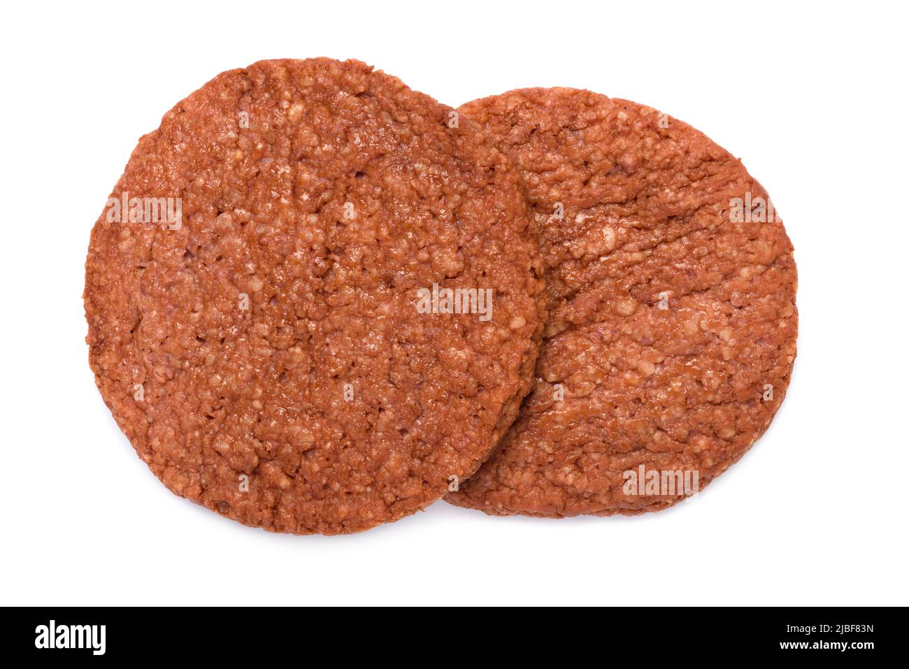 Two breaded chicken burger patties, intermediate good food, isolated on