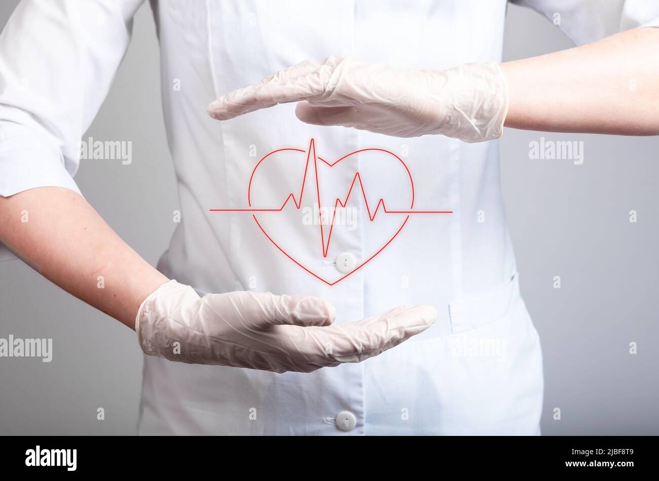 ECG concept. Doctor holding heart with heartbeat rhythm between hands in gloves. Electrocardiogram test conducting. Heart disease, attack detection. High quality photo Stock Photo