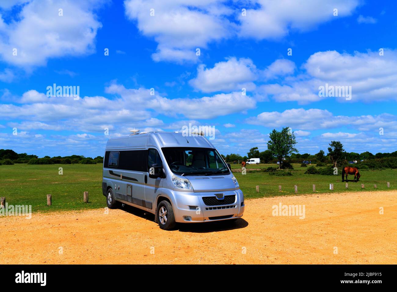 Motorhome camper van conversion by green field with pony and blue sky ...