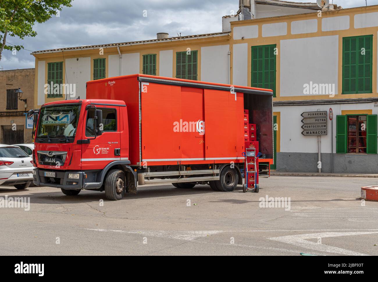 Felanitx, Spain; may 27 2022: Red beer delivery truck of the spanish brand Estrella Damm, parked on the street to make the delivery. Felanitx, Island Stock Photo