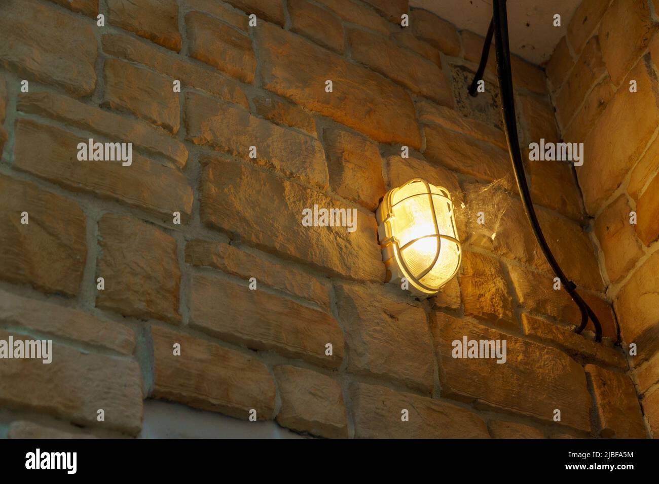 Electric lantern on a brick or stone wall Stock Photo