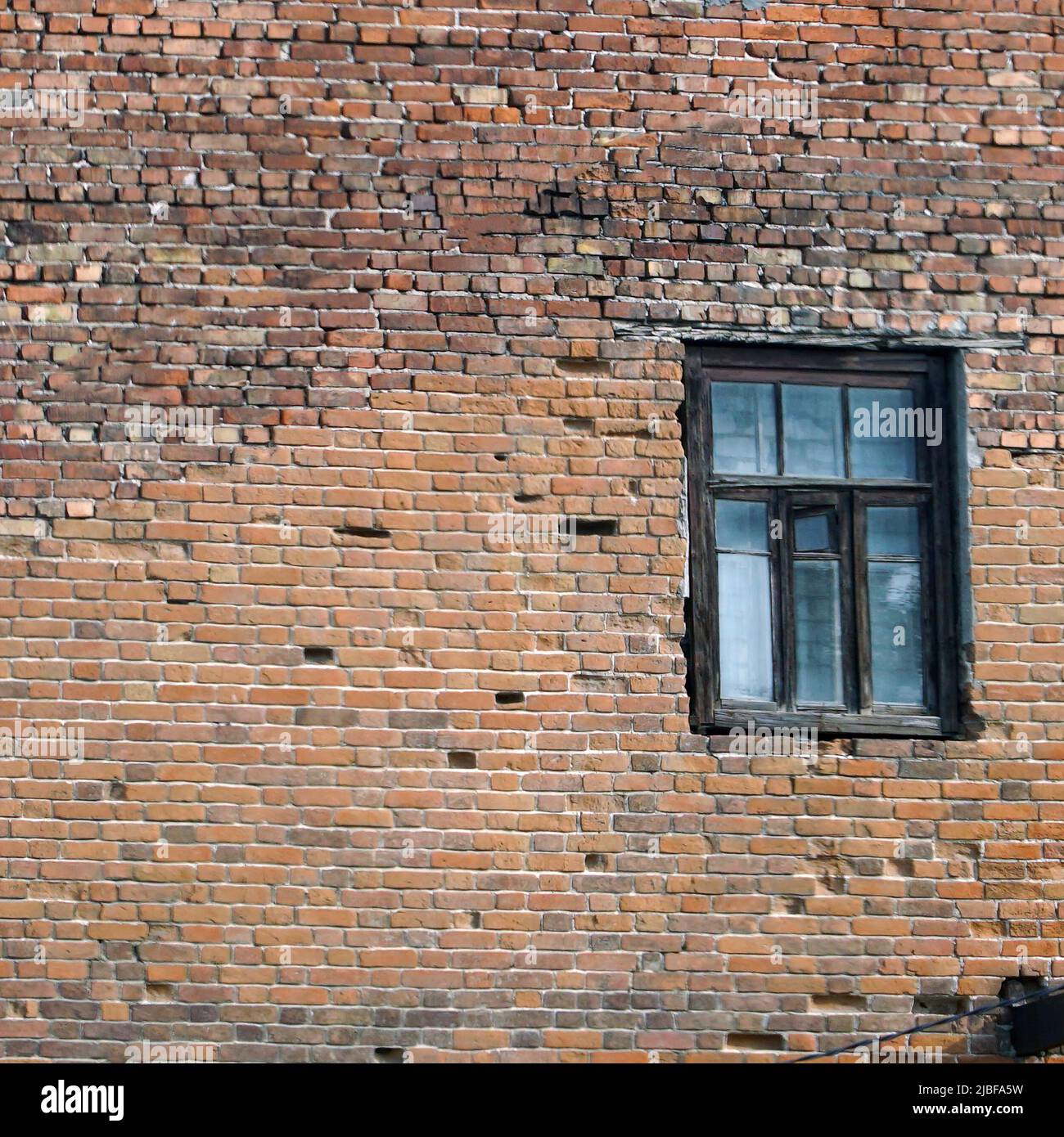 An abandoned old window in a dirty red brick wall Stock Photo - Alamy