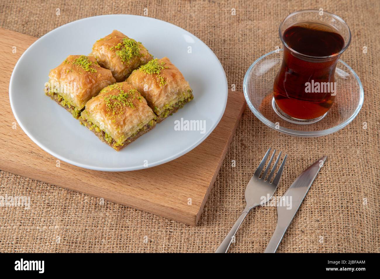 Traditional pistachio baklava with Turkish tea Stock Photo