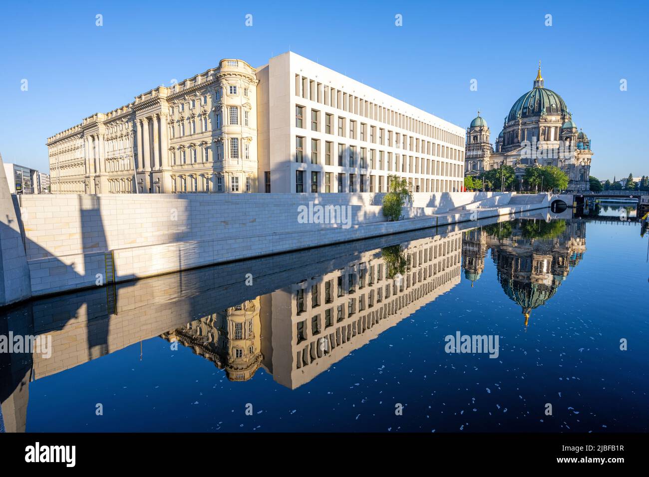 The rebuilt City Palace with the Berliner Dom reflected in the river Spree Stock Photo