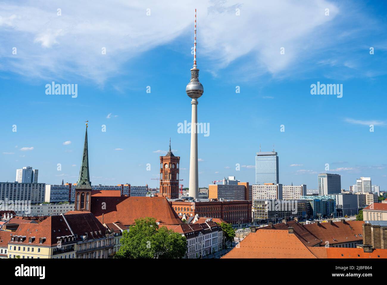 The famous TV Tower of Berlin with the town hall on a sunny day Stock Photo