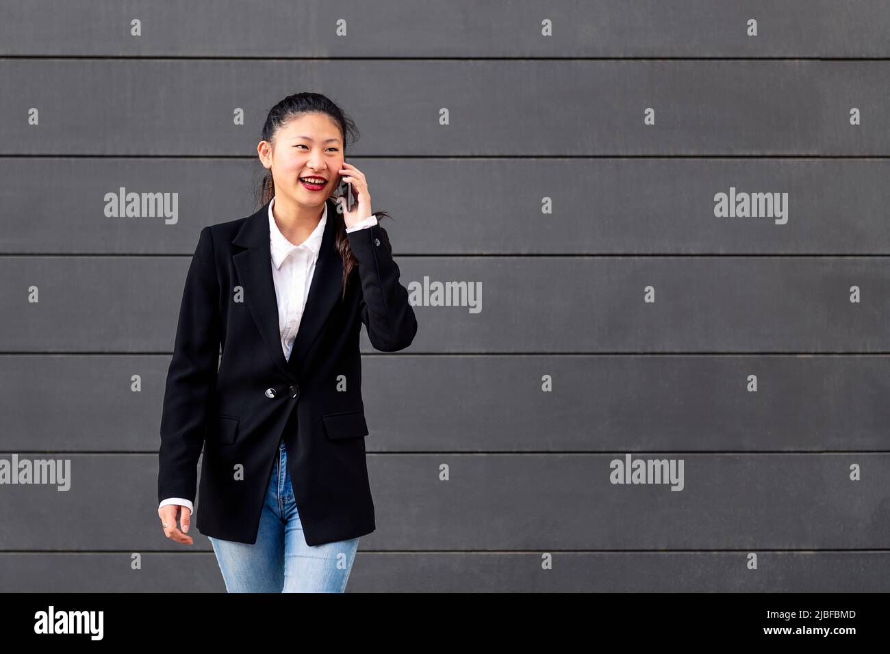 happy asiatic businesswoman talking on the phone Stock Photo