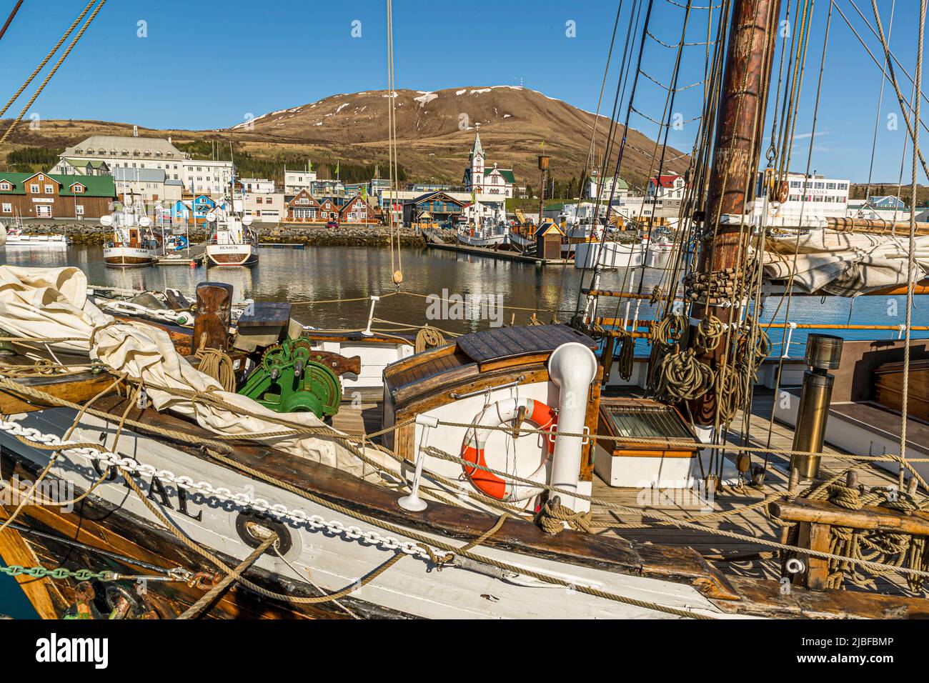In the harbor of Húsavík are moored numerous historic wooden sailboats Stock Photo
