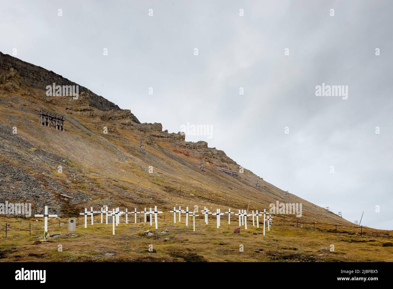 Grave markers by hill in Svalbard, Norway Stock Photo