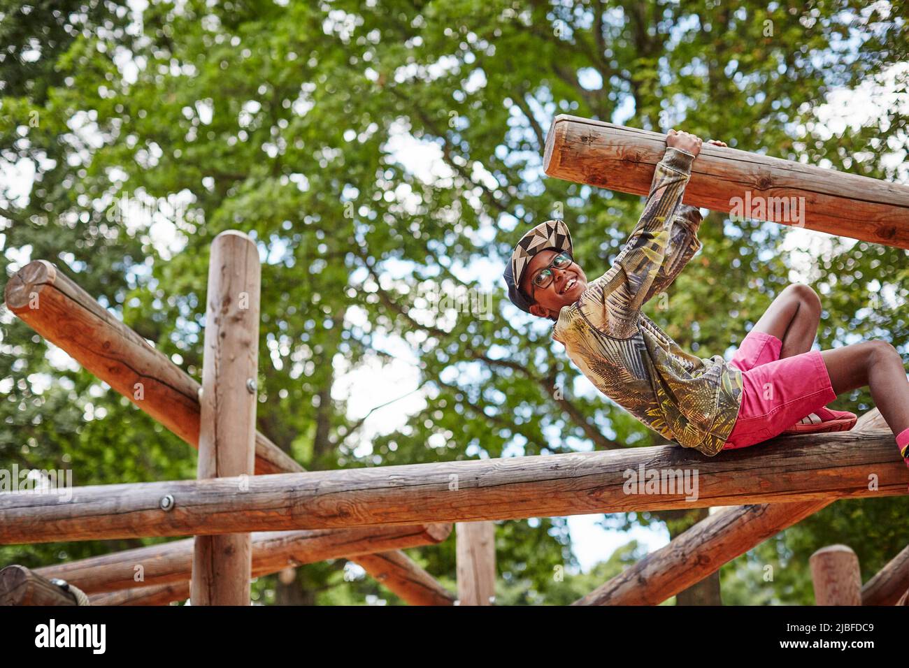 Boy playing on jungle gym Stock Photo Alamy