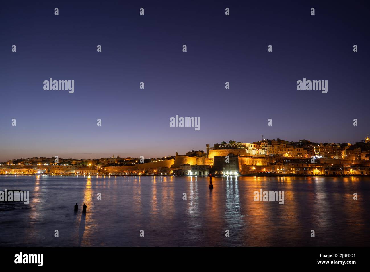 City of Valletta and Floriana town skyline in Malta at night, view from the Grand Harbour. Stock Photo