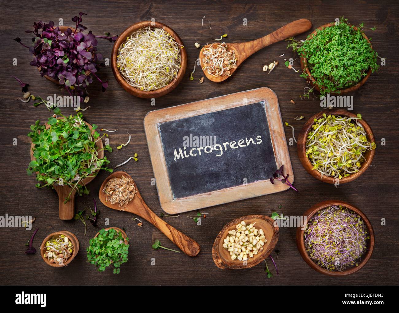 Different types of microgreens on a wooden background Stock Photo Alamy