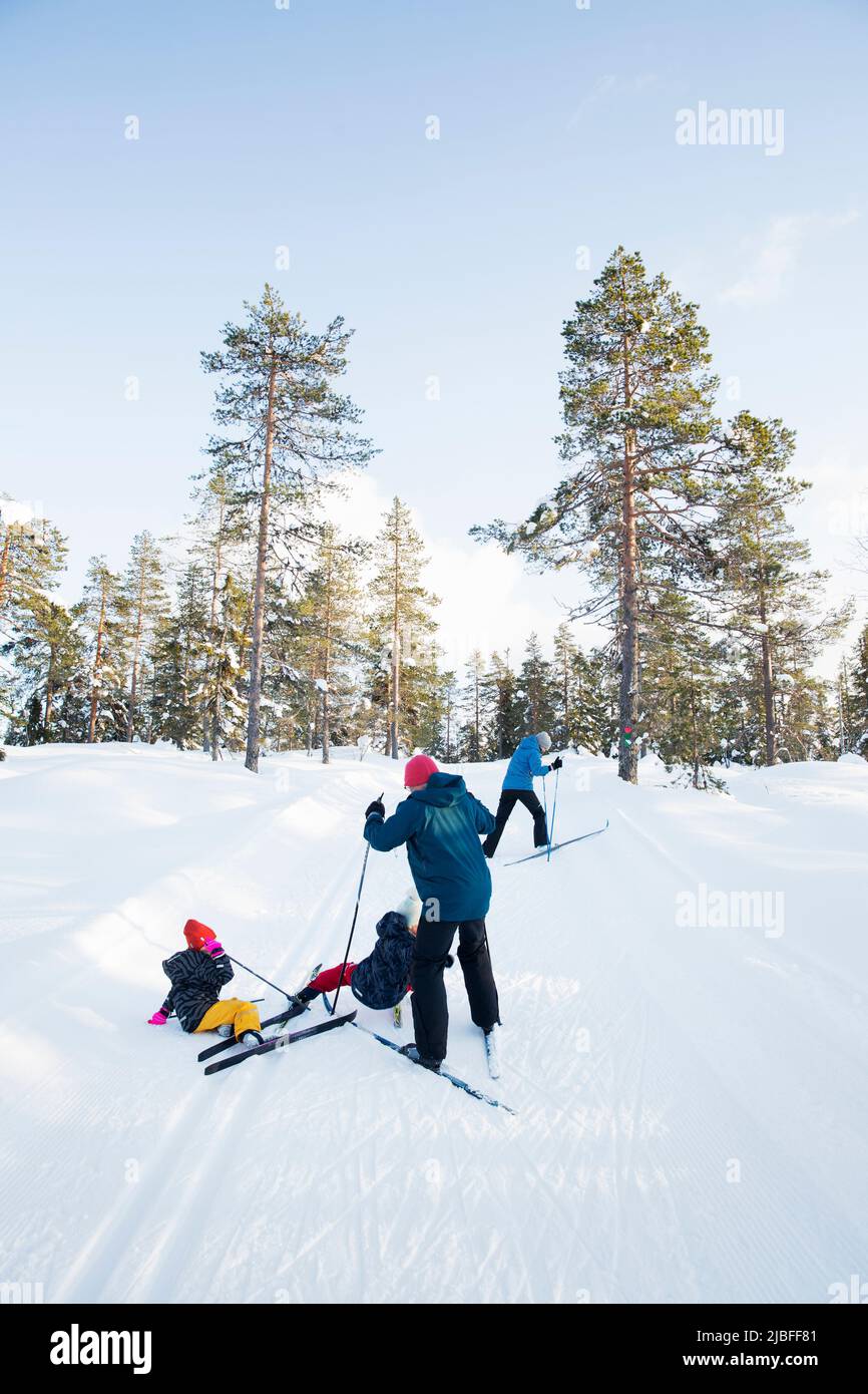 Family of four skiing on mountain Stock Photo