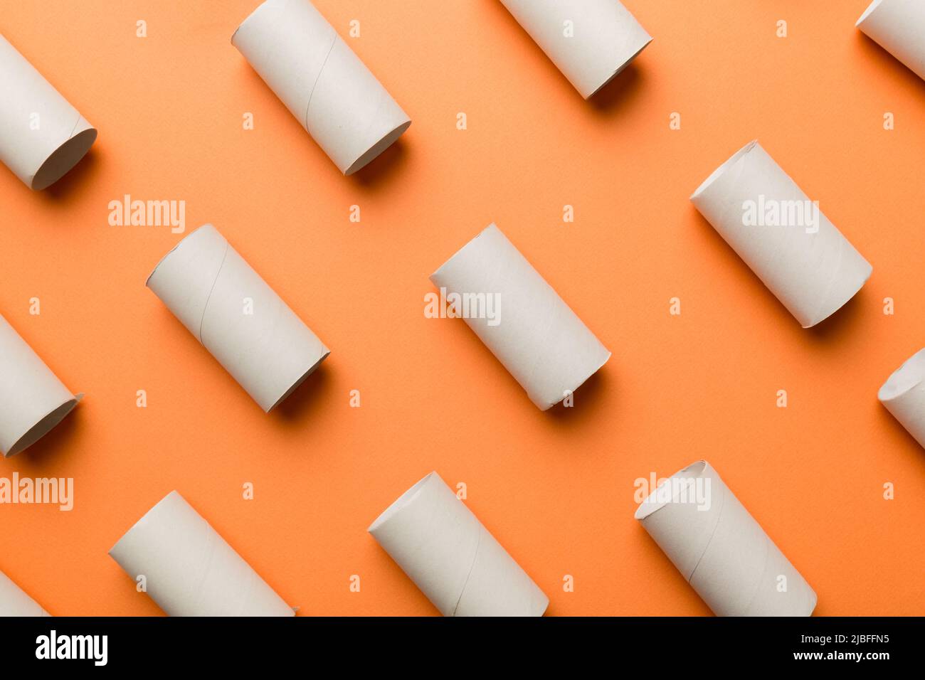 Empty toilet paper roll on colored background. Recyclable paper tube