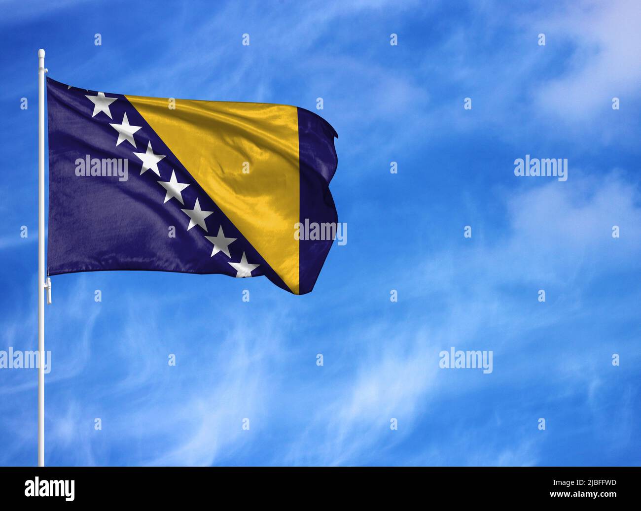 National flag of Bosnia and Herzegovina on a flagpole Stock Photo