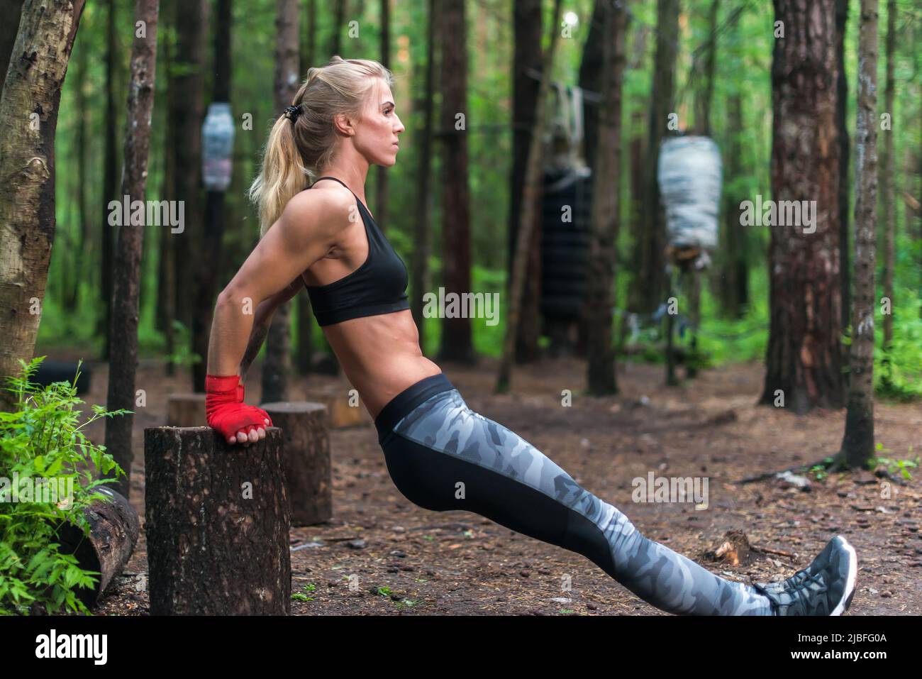 Woman exercising working out triceps and biceps doing dips with own