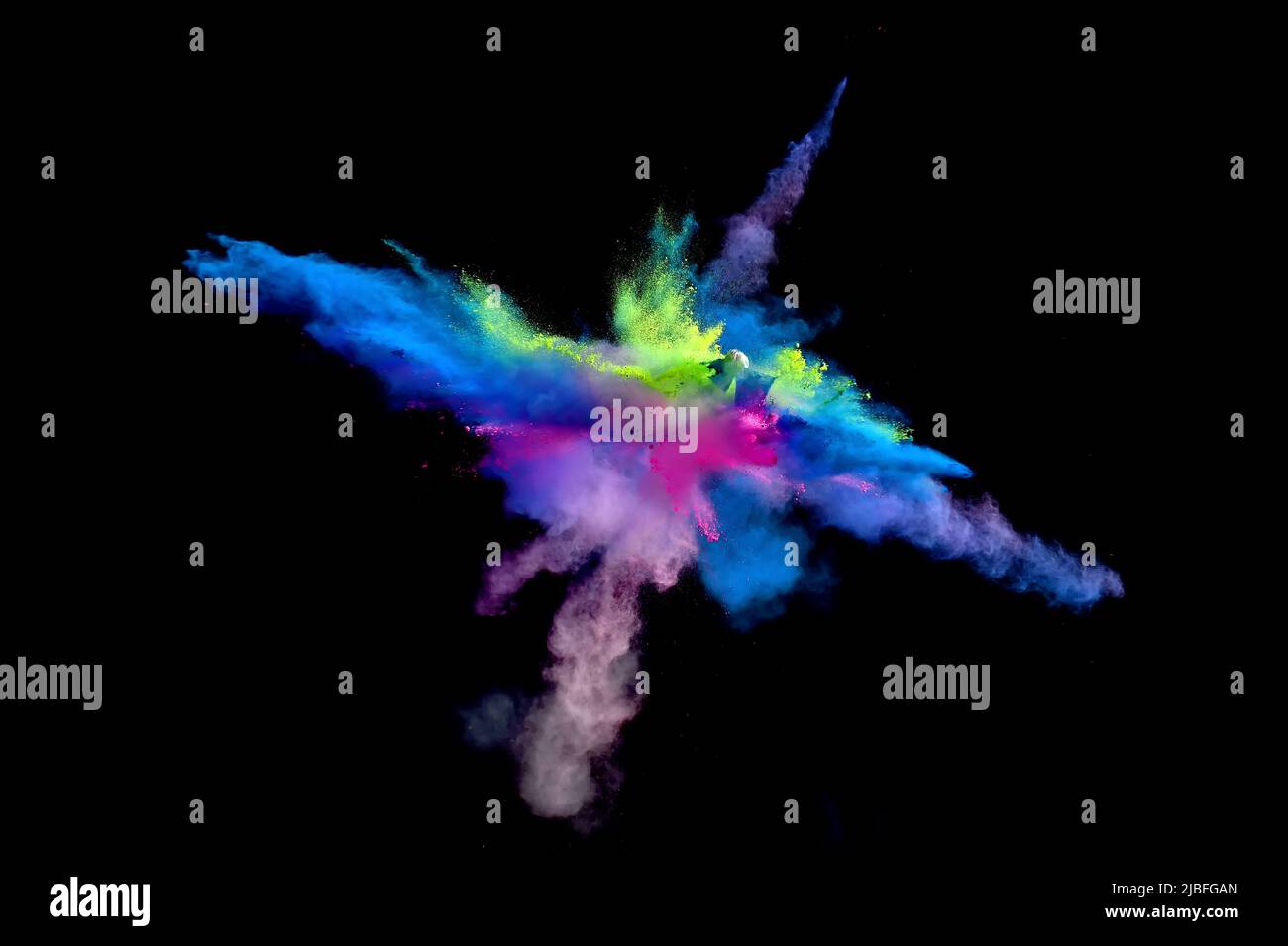 Various multicolored forms of powder paint explode in front of a black ...