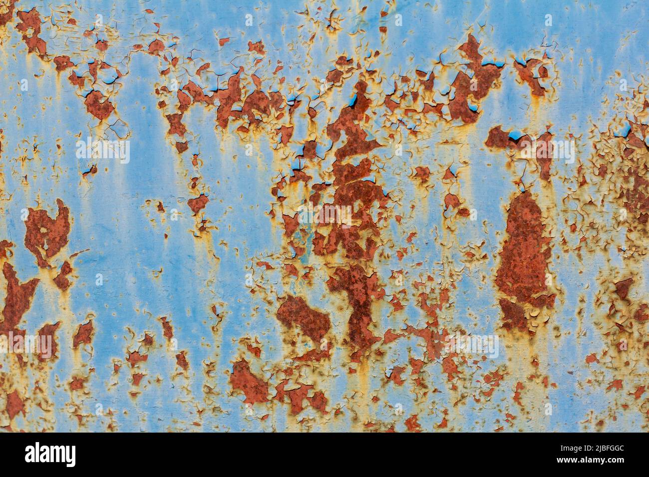 Rusty metal surface with blue cracked paint. Old rusty metal. Metal covered with rust Stock Photo
