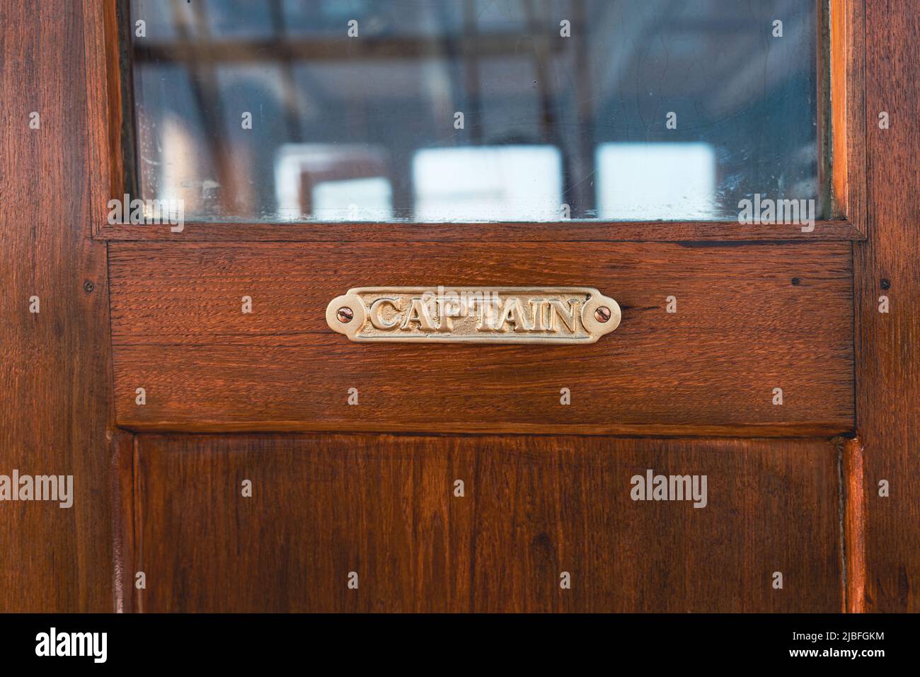 Wooden door to captain control room in the sailing boat Stock Photo